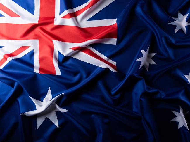 Australia day concept. Australian flag with the text Happy Australia day against a blackboard background. 26 January.