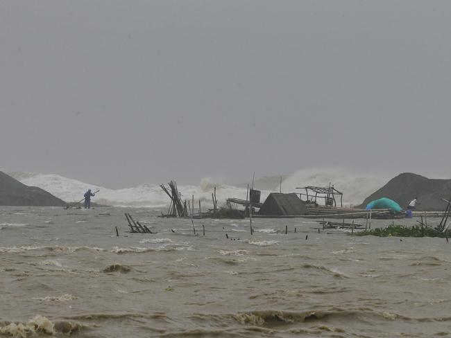 A fisherman works on his destroyed fish cages swamped by huge waves brought about by Super Typhoon Haima. Picture: AP