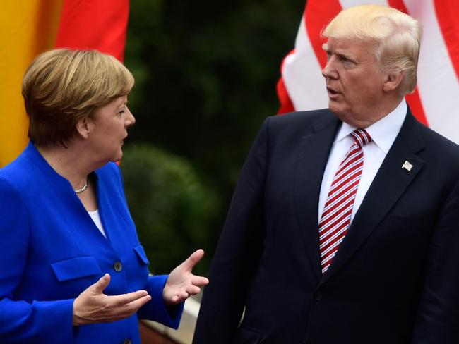 German Chancellor Angela Merkel talks with US President Donald Trump at the G7. AFP PHOTO / Miguel MEDINA