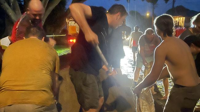 Grafton residents from all over helped out, quickly filling sandbags onto Moorhead’s truck on Monday night. Picture: Lexi Lamberth