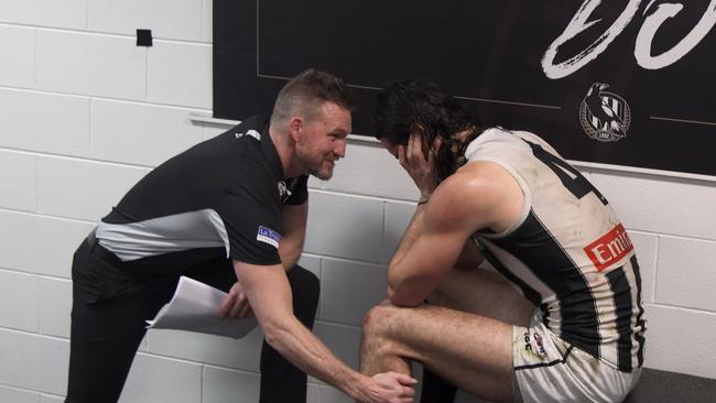 Nathan Buckley consoles Brodie Grundy in a scene from Collingwood: From The Inside Out, which showed the changes the club had made to its culture.