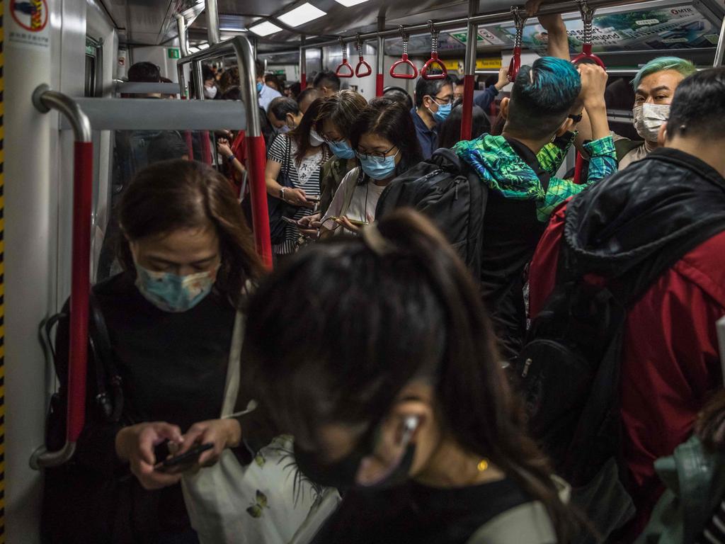 People commute on a train in Hong Kong as Covid cases surge. Picture: AFP