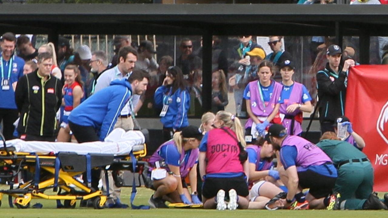 Bulldogs player Britney Gutknecht is treated by ambulance officers at Port Adelaide’s first ever home game at Alberton Oval. Picture: Emma Brasier