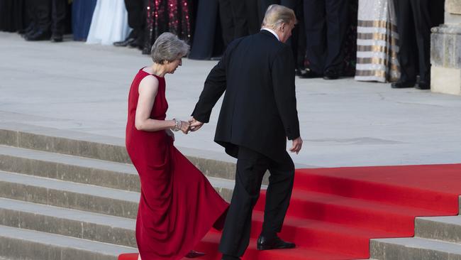 Donald Trump leads Theresa May into dinner. Picture: AP