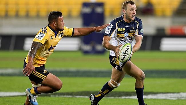 Brumbies fullback Jesse Mogg evades the defence of Hurricanes centre Alapati Leiua.