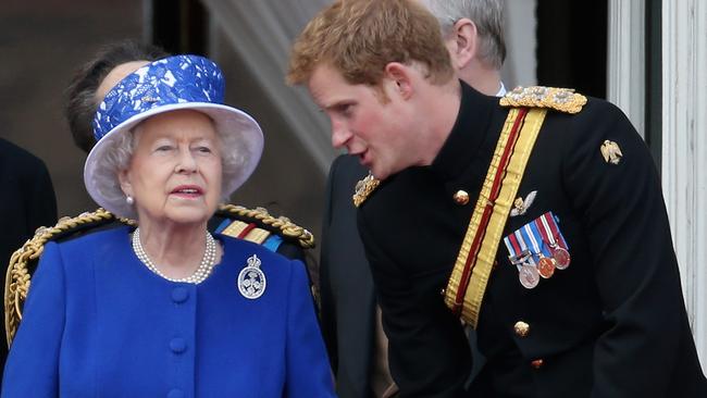 Prince Harry chats to Queen Elizabeth II on the balcony of Buckingham Palace during the annual Trooping the Colour Ceremony on June 15, 2013 in London. Picture: Getty