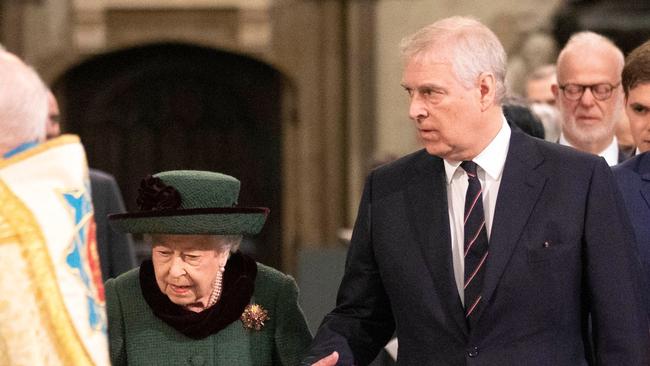 Prince Andrew escorts the Queen to a thanksgiving service for the Duke of Edinburgh at Westminster Abbey in March. Picture: AFP