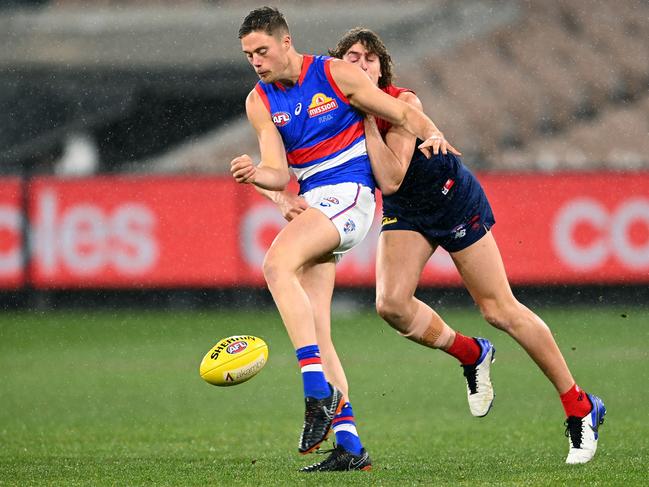 Josh Schache gets his kick away despite pressure from Luke Jackson, Picture: Quinn Rooney/Getty Images