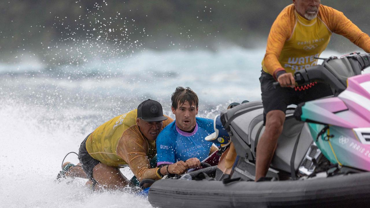 Jack Robinson of Team Australia is rescued by water patrol after falling during round three of surfing on day three of the Olympic Games Paris 2024 on July 29, 2024 in Teahupo'o, French Polynesia. (Photo by Ed Sloane / POOL / AFP)