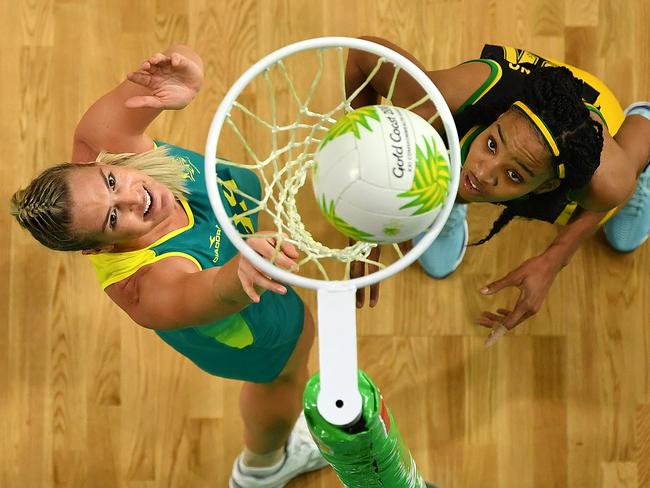 GOLD COAST, AUSTRALIA - APRIL 11:  Caitlin Bassett of Australia (L) scores a goal during the Netball Pool A match between Australia and Jamaica on day seven of the Gold Coast 2018 Commonwealth Games at Gold Coast Convention Centre on April 11, 2018 on the Gold Coast, Australia. (Photo by Dan Mullan/Getty Images)