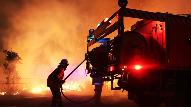 Firefighters put in a back burn to stop fire progression towards houses at Barden Ridge. Picture: Dean Asher