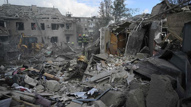 Ukrainian rescuers clear debris on the site of a Russian missile strike in Dnipro, eastern Ukraine, on Saturday. Picture: AFP