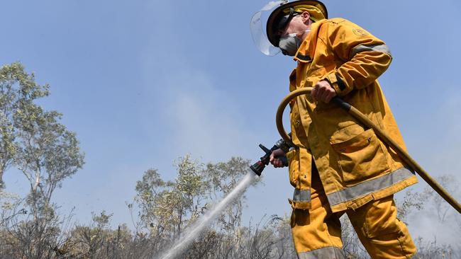 A firefighter working to strengthen containment lines at Noosa North Shore. Picture: Patrick Woods