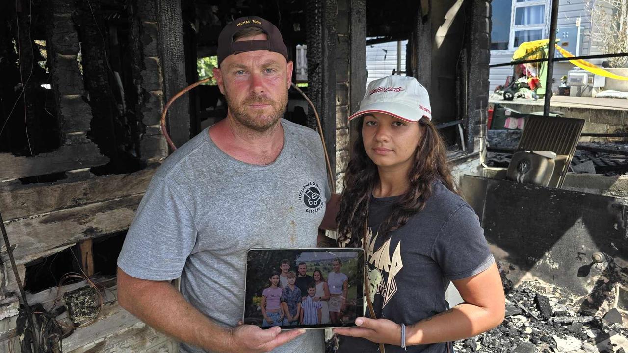 Daniel and Gemma O'Brien with the shards of what's left of their family home after a blaze tore through their house on Sunday. Picture: Luke Kane