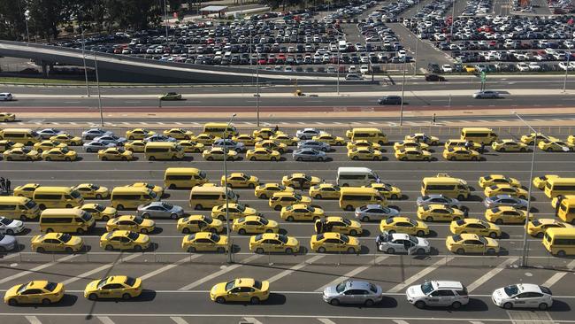 Waiting cabs start to move off outside the Terminal 4 car park this afternoon. Picture: Ashley Argoon