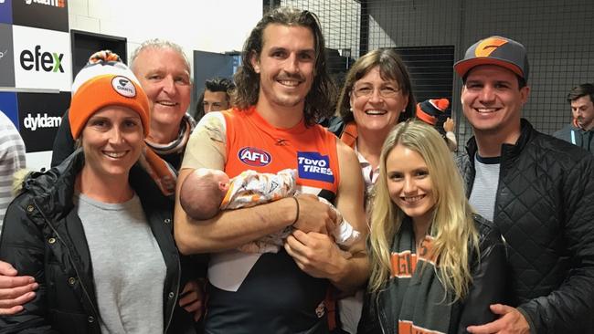 Phil Davis holds his niece, Zara, with his girlfriend, Greta, sister Kath, brother-in-law Ben, dad Merv and mum, Jane.