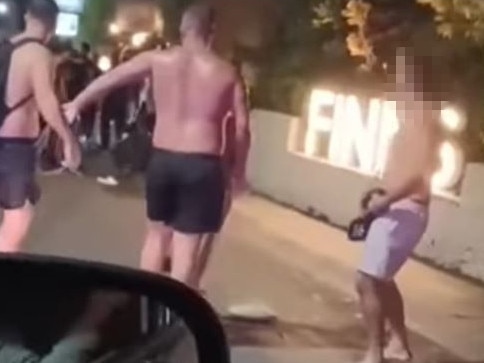 Video footage reportedly shows shirtless Australian tourist and his mates wielding what appear to be planks of wood during a brawl outside Finns Beach Club.