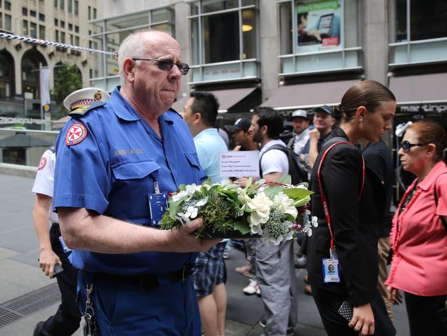 People lay flowers at the memorial. Pic John Grainger