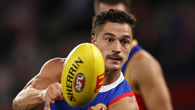 MELBOURNE . 30/03/2023.  AFL Round 3.   Western Bulldogs vs Brisbane Lions  at Marvel Stadium.   Bulldog Riley Garcia clears by hand . Pic: Michael Klein