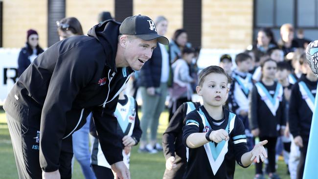 Port Adelaide defender Tom Clurey at a coaching clinic junior club members on Monday. Picture SARAH REED