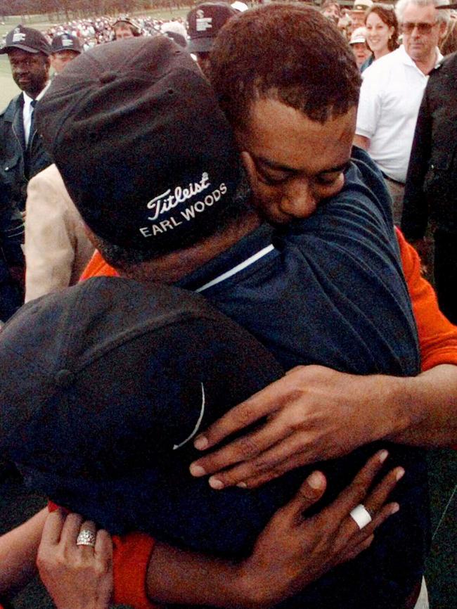 Eldrick "Tiger" Woods hugs his father Earl after winning 1997 US Masters.