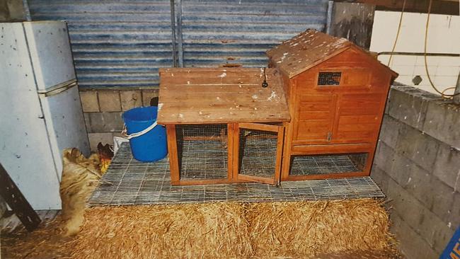 The couch covered by a chicken coop and hay bales. Picture: SA Police