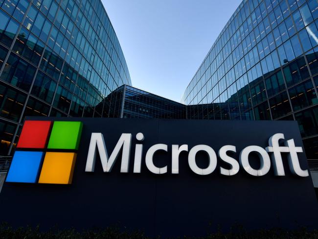 (FILES) In this file photo taken on March 05, 2018 the logo of French headquarters of American multinational technology company Microsoft, is pictured outside on March 6, 2018 in Issy-Les-Moulineaux, a Paris' suburb. - With each passing quarter, Amazon, Microsoft and Google have been setting new records, while cloud computing has become the invisible backbone supporting much of our daily lives. Its potential to become an even bigger part of people's daily existence is sky-high. (Photo by GERARD JULIEN / AFP)
