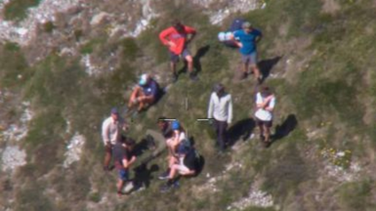 Mr Nazari surrounded by hikers who found him off the circuit walk near Blue Lake. Picture: NSW RFS