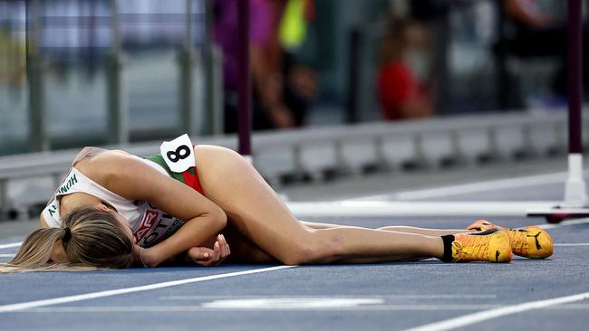 Hungary's athlete Anna Toth lies on the track. Photo by Anne-Christine POUJOULAT / AFP