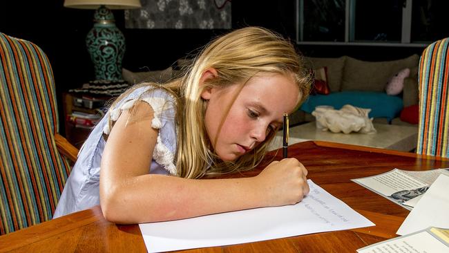 Coralie Bradnam writing a letter to the Queen. Picture: Jerad Williams