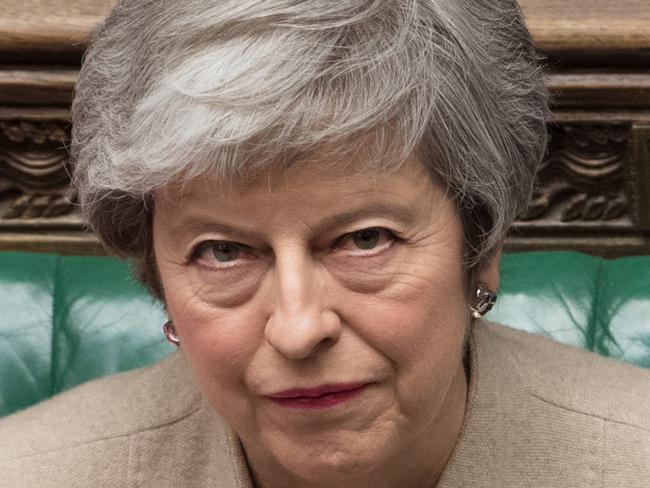 A handout photograph taken and released by the UK Parliament on March 29, 2019 shows Britain's Prime Minister Theresa May listening to a speaker during a a debate in the House of Commons on the Government's Withdrawal Agreement Bill, before MPs voted on it. - British MPs on Friday rejected Prime Minister Theresa May's EU divorce deal for a third time, opening the way for a long delay to Brexit -- or a potentially catastophic "no deal" withdrawal in two weeks. (Photo by MARK DUFFY / UK PARLIAMENT / AFP) / EDITORS NOTE THE IMAGE HAS BEEN DIGITALLY ALTERED AT SOURCE TO OBSCURE VISIBLE DOCUMENTS  - RESTRICTED TO EDITORIAL USE - NO USE FOR ENTERTAINMENT, SATIRICAL, ADVERTISING PURPOSES - MANDATORY CREDIT " AFP PHOTO /Mark DUFFY/ UK Parliament"