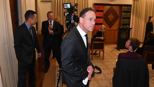 Greg Hunt leaves the press conference followed by Victoria and Tasmania Consul-General of China Long Zhou and Andrew Forrest. Picture: AAP.