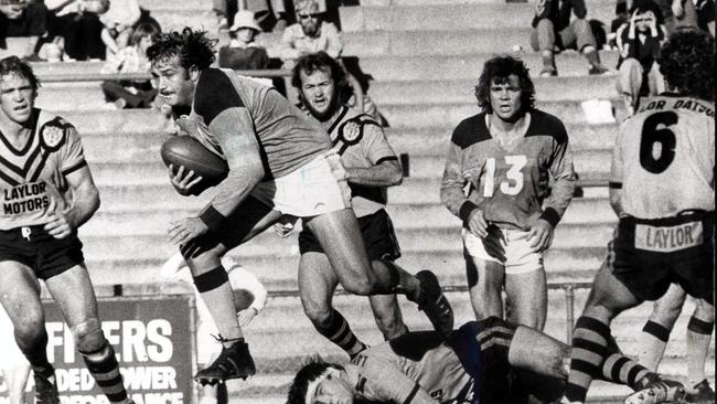 Norths prop Darryl Brohman breaks out of a tackle by Easts Rod Morris at Lang Park 26 Jun 1977. Des Morris (L) sport rugby league action BRL QRL 35/P/3936/28