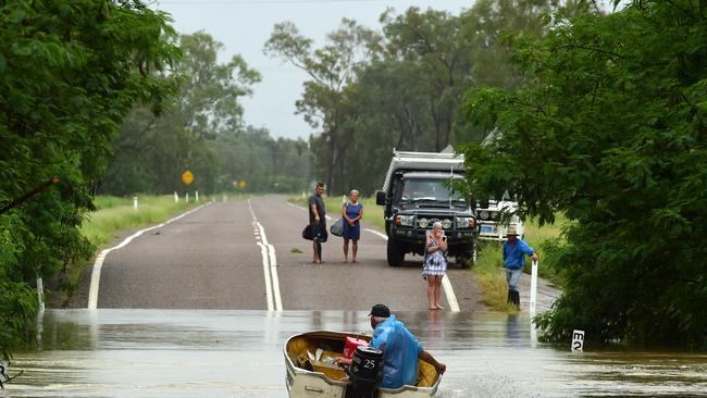 Wet weather in Townsville. Poultry farmer Jeff Ironside heads back for more after bringing people across the Bohle River, cut by flood water at Allambie Lane. Picture: Evan Morgan