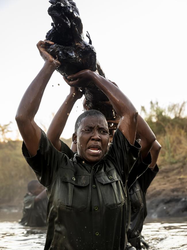 Members of the all female conservation ranger force known as Akashinga undergo tough training in the bush near their base.