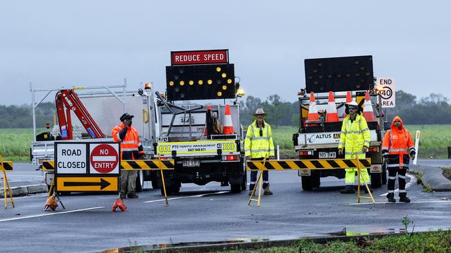 The department of Transport and Main Roads was forced to close the Captain Cook Highway between Holloway's Beach and Smithfield on Thursday after heavy rain swelled Thomatis Creek, pushing flood water and debris over the road. Picture: Brendan Radke