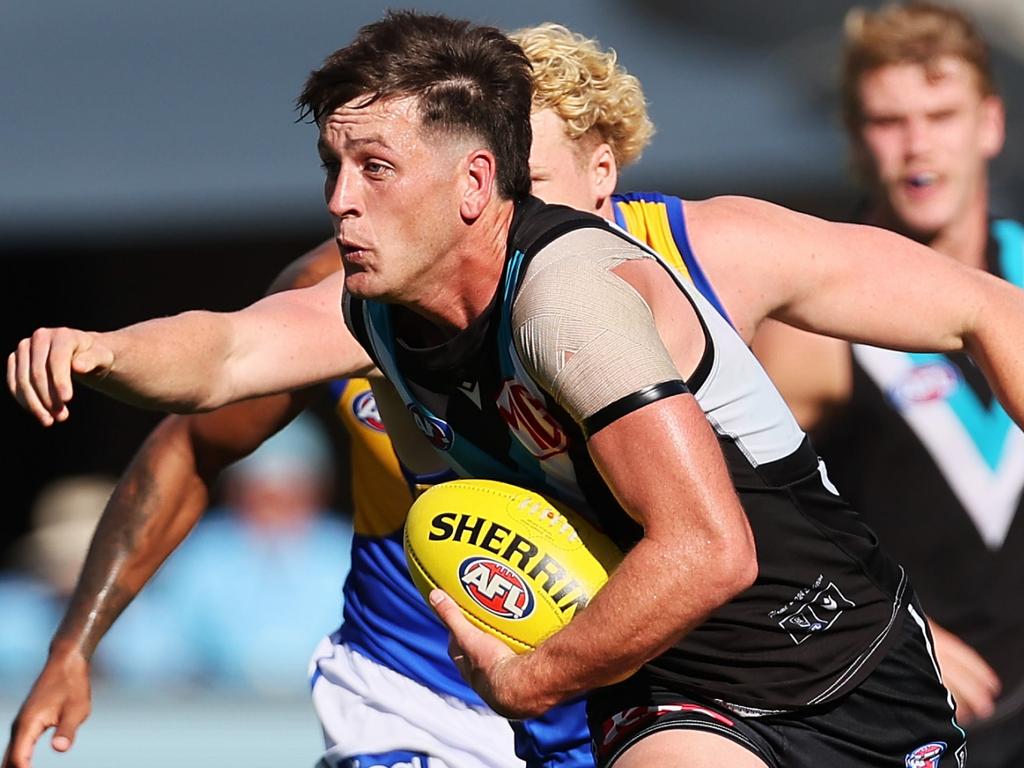 ADELAIDE, AUSTRALIA – MARCH 17: Zak Butters of the Power is tackled by Reuben Ginbey of the Eagles during the 2024 AFL Round 01 match between the Port Adelaide Power and the West Coast Eagles at Adelaide Oval on March 17, 2024 in Adelaide, Australia. (Photo by James Elsby/AFL Photos via Getty Images)