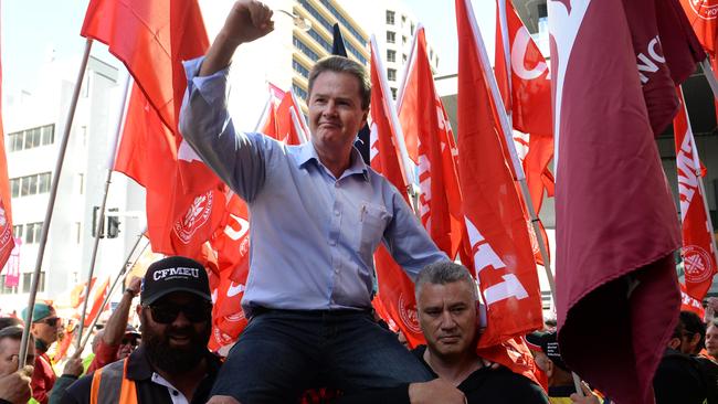 Michael Ravba is carried into the magistrate court by supporters in Brisbane last year.