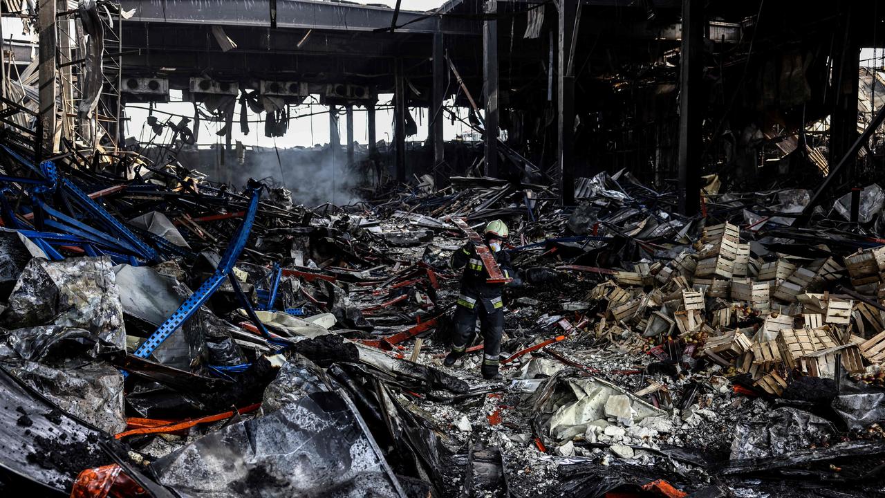 A rescuer clears the rubble of a warehouse in the town of Brovary, north of Ukrainian capital of Kyiv, after being destroyed by a Russian shelling. Picture: Ronaldo Schemidt/AFP