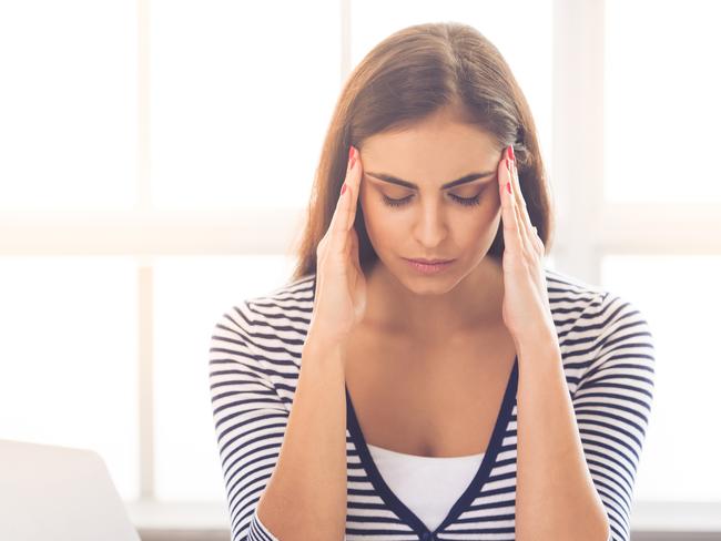 Beautiful tired business lady in smart casual wear is massaging her temples while sitting with closed eyes at desk in office. financial advice, adviser, stress, money generic