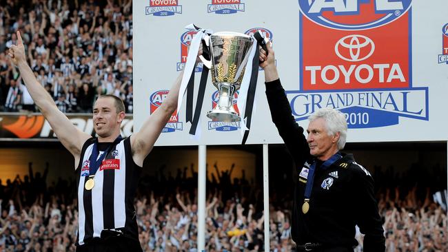 Collingwood captain Nick Maxwell and Mick Malthouse hoist aloft the 2010 premiership cup.