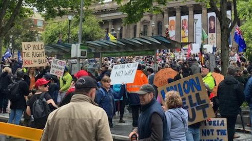 The crowd carried signs and banners. Picture: Sarah Perillo