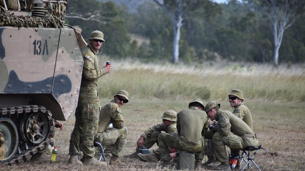 Soldiers by an armoured personnel carrier at the Shoalwater Bay Training Area.