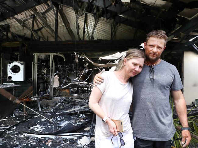 Melissa and Bevin Cunniffe survey what remains of their Cornubia home. Picture: Liam Kidston