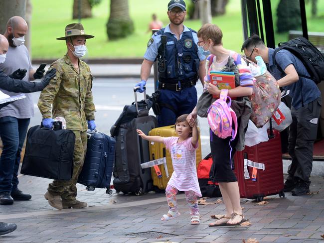 Returning overseas travellers are ushered into the Intercontinental Hotel for the beginning of their 14-day imposed quarantine in Sydney on Sunday, March 29. Picture: AAP Image/Jeremy Piper