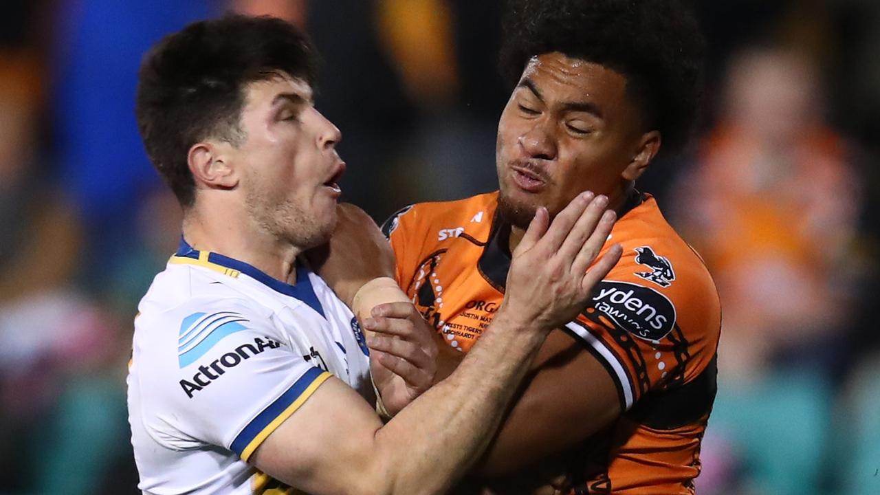 SYDNEY, AUSTRALIA - JULY 09: Mitchell Moses of the Eels is tackled by Justin Matamua of the Tigers during the round 17 NRL match between the Wests Tigers and the Parramatta Eels at Leichhardt Oval on July 09, 2022 in Sydney, Australia. (Photo by Jason McCawley/Getty Images)