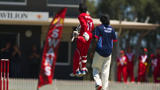 “Uber’’ Deshpande jumps for join after reaching his century. Pic: Chris Thomas.