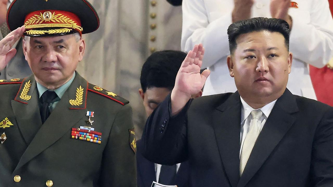 North Korea's leader Kim Jong-un (R) attending a military parade to mark a key anniversary of the Korean War, with Russia's Defence Minister Sergei Shoigu. (Photo by KCNA VIA KNS / AFP).