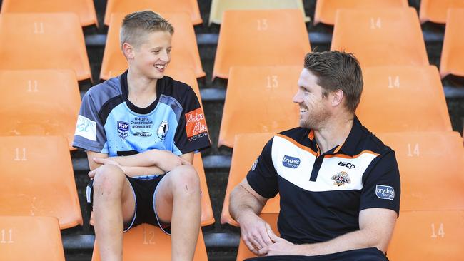 West Tigers star Chris Lawrence with under 14s player Adam Wallace yesterday at Concord Oval. Picture: Dylan Robinson