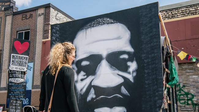 A woman stands in front of a mural of George Floyd in Minneapolis, Minnesota. Picture: Getty